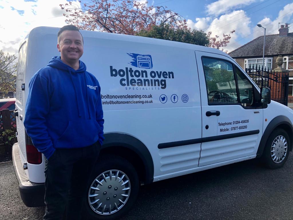Neil Cain stood in front of the Bolton Oven Cleaning Specialists van (side view of van)
