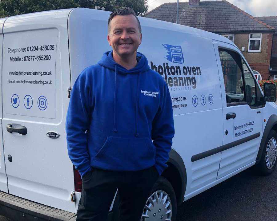 Neil Cain stood next to the Bolton Oven Cleaning Specialists Van